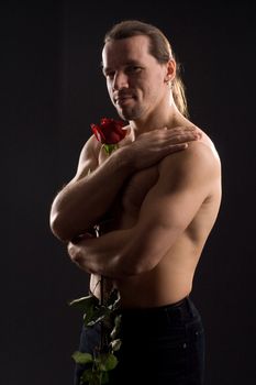 standing romantic man with red rose
