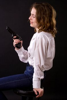 woman on black handing gun
