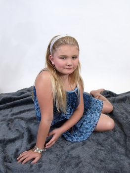 A young girl sitting in a summer dress