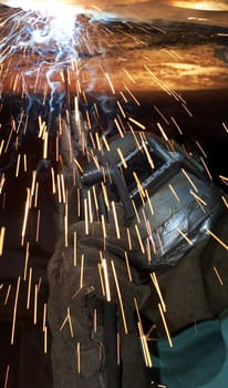 a welder working at shipyard under vessel