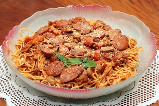 spaghetti sausage pasta served in a dish
