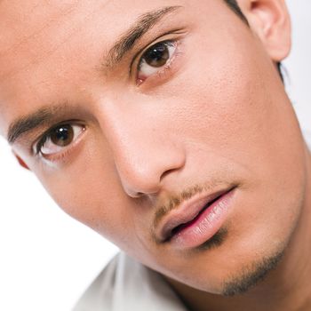 Studio portrait of mixed race young man looking serious