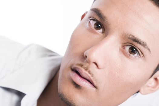 Studio portrait of mixed race young man looking pensive