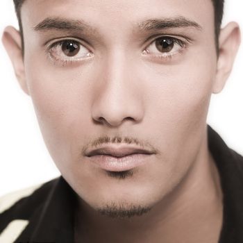 Studio portrait of mixed race young man in duo-tone