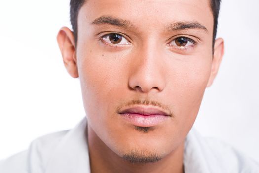 Studio portrait of mixed race young man looking neutral