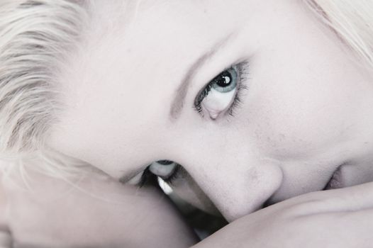 Studio portrait of a blond young lady looking dreamy