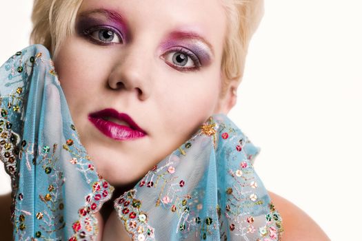 Studio portrait of a blond young lady with a silk scarf