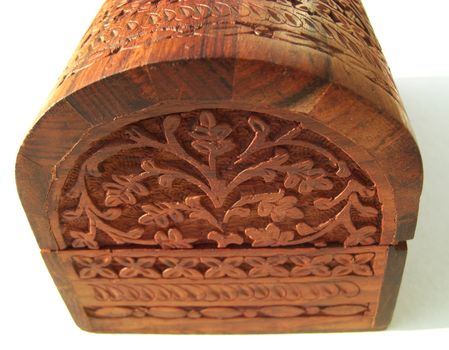 Wooden oriental box on light background, woodcarving with floral ornaments