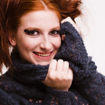 Studio portrait of a natural redhead laughing
