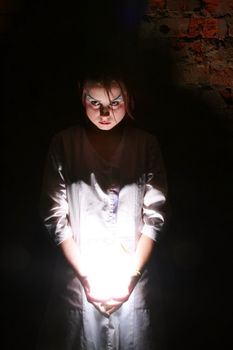 The young girl holds light in hands