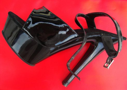 stiletto-heeled shoe made of patent leather, single object