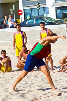 CADIZ, SPAIN - JULY 19: Unidentified players compete in a match between Los Negritos and Ademar Adentro in the 19th league of beach handball of Cadiz on July 19, 2011 in Cadiz, Spain