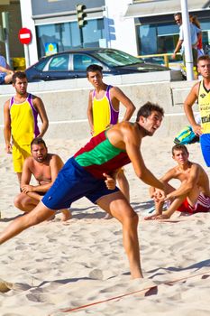 CADIZ, SPAIN - JULY 19: Unidentified players compete in a match between Los Negritos and Ademar Adentro in the 19th league of beach handball of Cadiz on July 19, 2011 in Cadiz, Spain