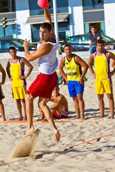 CADIZ, SPAIN - JULY 19: Unidentified players compete in a match between Los Negritos and Ademar Adentro in the 19th league of beach handball of Cadiz on July 19, 2011 in Cadiz, Spain
