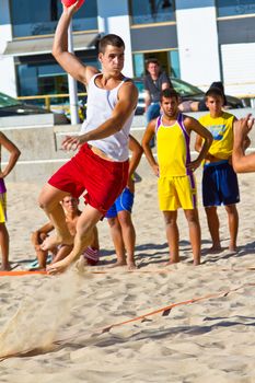 CADIZ, SPAIN - JULY 19: Unidentified players compete in a match between Los Negritos and Ademar Adentro in the 19th league of beach handball of Cadiz on July 19, 2011 in Cadiz, Spain