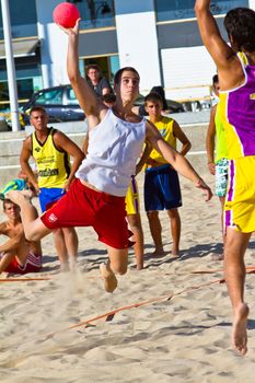 CADIZ, SPAIN - JULY 19: Unidentified players compete in a match between Los Negritos and Ademar Adentro in the 19th league of beach handball of Cadiz on July 19, 2011 in Cadiz, Spain