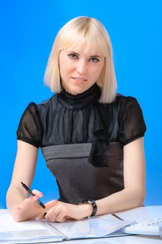 Beautiful young girl in a business clothes working in the office