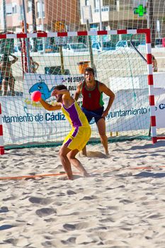 CADIZ, SPAIN - JULY 19: Unidentified players compete in a match between Los Negritos and Ademar Adentro in the 19th league of beach handball of Cadiz on July 19, 2011 in Cadiz, Spain
