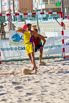 CADIZ, SPAIN - JULY 19: Unidentified players compete in a match between Los Negritos and Ademar Adentro in the 19th league of beach handball of Cadiz on July 19, 2011 in Cadiz, Spain