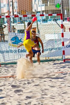CADIZ, SPAIN - JULY 19: Unidentified players compete in a match between Los Negritos and Ademar Adentro in the 19th league of beach handball of Cadiz on July 19, 2011 in Cadiz, Spain