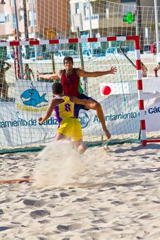 CADIZ, SPAIN - JULY 19: Unidentified players compete in a match between Los Negritos and Ademar Adentro in the 19th league of beach handball of Cadiz on July 19, 2011 in Cadiz, Spain