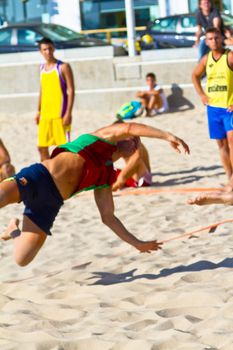 CADIZ, SPAIN - JULY 19: Unidentified players compete in a match between Los Negritos and Ademar Adentro in the 19th league of beach handball of Cadiz on July 19, 2011 in Cadiz, Spain