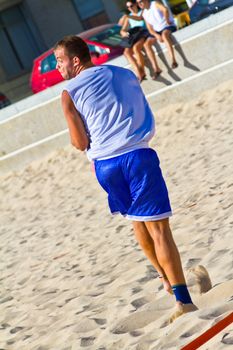 CADIZ, SPAIN - JULY 19: Unidentified players compete in a match between Los Negritos and Ademar Adentro in the 19th league of beach handball of Cadiz on July 19, 2011 in Cadiz, Spain