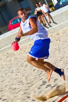CADIZ, SPAIN - JULY 19: Unidentified players compete in a match between Los Negritos and Ademar Adentro in the 19th league of beach handball of Cadiz on July 19, 2011 in Cadiz, Spain