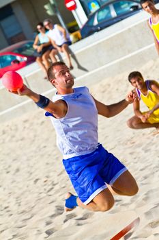 CADIZ, SPAIN - JULY 19: Unidentified players compete in a match between Los Negritos and Ademar Adentro in the 19th league of beach handball of Cadiz on July 19, 2011 in Cadiz, Spain