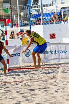 CADIZ, SPAIN - JULY 19: Unidentified players compete in a match between Los Negritos and Ademar Adentro in the 19th league of beach handball of Cadiz on July 19, 2011 in Cadiz, Spain