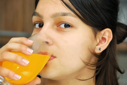 cute caucasian teenage girl portrait drinking yellow juice