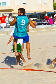 CADIZ, SPAIN - JULY 19: Unidentified players compete in a match between BMPY LAM Chiclana and Los Legendarios in the 19th league of beach handball of Cadiz on July 19, 2011 in Cadiz, Spain