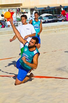 CADIZ, SPAIN - JULY 19: Unidentified players compete in a match between BMPY LAM Chiclana and Los Legendarios in the 19th league of beach handball of Cadiz on July 19, 2011 in Cadiz, Spain