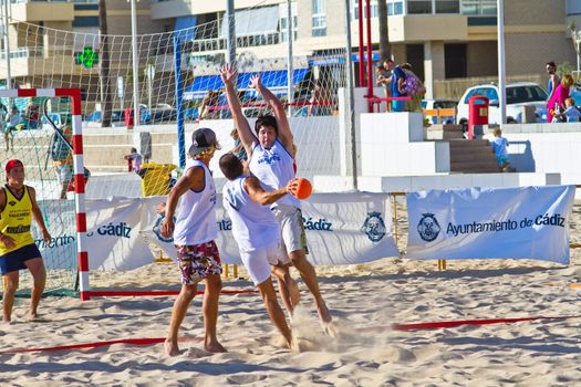 CADIZ, SPAIN - JULY 19: Unidentified players compete in a match between Valcarcel Recuperado and DecoHogar in the 19th league of beach handball of Cadiz on July 19, 2011 in Cadiz, Spain