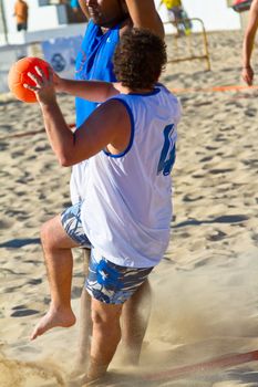 CADIZ, SPAIN - JULY 19: Unidentified players compete in a match between Valcarcel Recuperado and DecoHogar in the 19th league of beach handball of Cadiz on July 19, 2011 in Cadiz, Spain