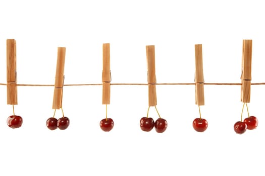 Sweet red cherries and clothes line isolated on a white background