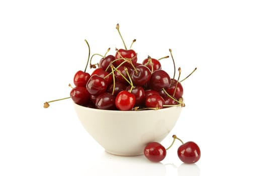 Sweet red cherries in ceramic bowl isolated on a white background