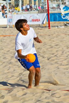 CADIZ, SPAIN - JULY 19: Unidentified players compete in a match between BMPY LAM Chiclana and Los Legendarios in the 19th league of beach handball of Cadiz on July 19, 2011 in Cadiz, Spain