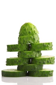pile of cucumber slices isolated on a white background
