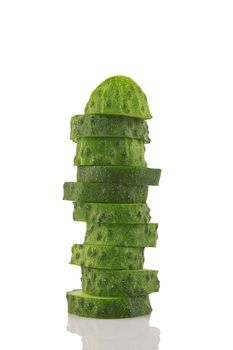 pile of cucumber slices isolated on a white background