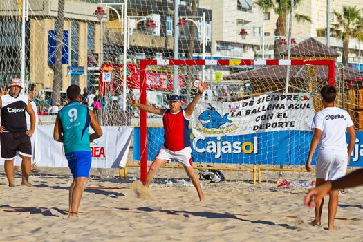 CADIZ, SPAIN - JULY 19: Unidentified players compete in a match between BMPY LAM Chiclana and Los Legendarios in the 19th league of beach handball of Cadiz on July 19, 2011 in Cadiz, Spain