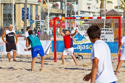 CADIZ, SPAIN - JULY 19: Unidentified players compete in a match between BMPY LAM Chiclana and Los Legendarios in the 19th league of beach handball of Cadiz on July 19, 2011 in Cadiz, Spain