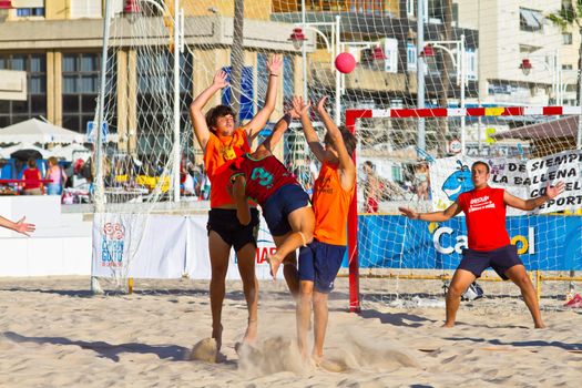 CADIZ, SPAIN - JULY 19: Unidentified players compete in a match between Los Negritos and Autoescuela Barquin in the 19th league of beach handball of Cadiz on July 19, 2011 in Cadiz, Spain