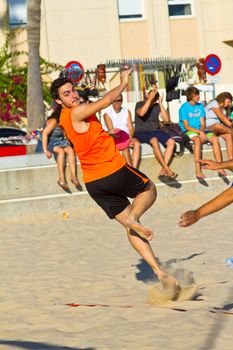 CADIZ, SPAIN - JULY 19: Unidentified players compete in a match between Los Negritos and Autoescuela Barquin in the 19th league of beach handball of Cadiz on July 19, 2011 in Cadiz, Spain