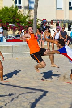 CADIZ, SPAIN - JULY 19: Unidentified players compete in a match between Los Negritos and Autoescuela Barquin in the 19th league of beach handball of Cadiz on July 19, 2011 in Cadiz, Spain