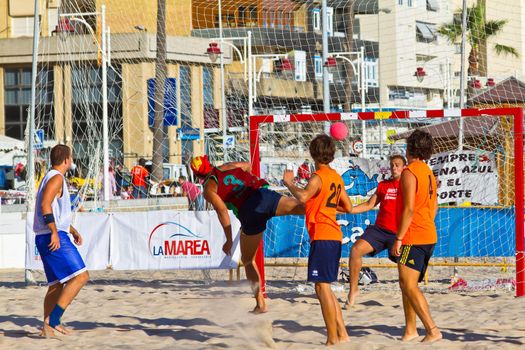 CADIZ, SPAIN - JULY 19: Unidentified players compete in a match between Los Negritos and Autoescuela Barquin in the 19th league of beach handball of Cadiz on July 19, 2011 in Cadiz, Spain