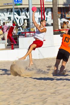 CADIZ, SPAIN - JULY 19: Unidentified players compete in a match between Los Negritos and Autoescuela Barquin in the 19th league of beach handball of Cadiz on July 19, 2011 in Cadiz, Spain