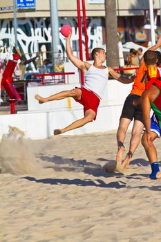 CADIZ, SPAIN - JULY 19: Unidentified players compete in a match between Los Negritos and Autoescuela Barquin in the 19th league of beach handball of Cadiz on July 19, 2011 in Cadiz, Spain