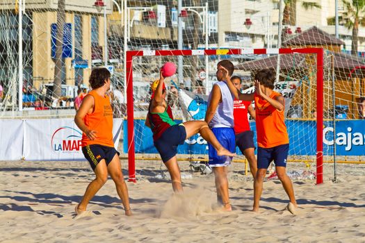 CADIZ, SPAIN - JULY 19: Unidentified players compete in a match between Los Negritos and Autoescuela Barquin in the 19th league of beach handball of Cadiz on July 19, 2011 in Cadiz, Spain