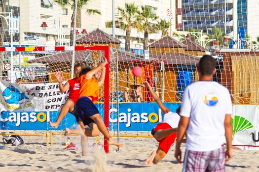 CADIZ, SPAIN - JULY 19: Unidentified players compete in a match between Los Negritos and Autoescuela Barquin in the 19th league of beach handball of Cadiz on July 19, 2011 in Cadiz, Spain